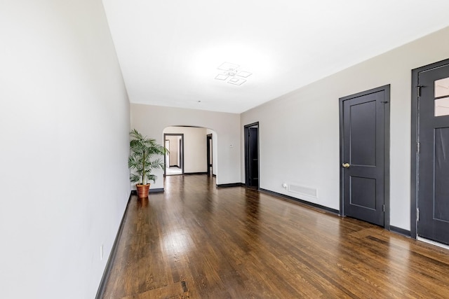 292 W 15th Pl, Chicago Heights, IL 60411 - spare room featuring arched walkways, baseboards, visible vents, and wood finished floors