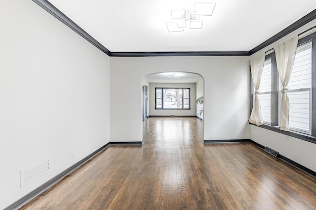 292 W 15th Pl, Chicago Heights, IL 60411 - empty room featuring visible vents, arched walkways, crown molding, and wood finished floors