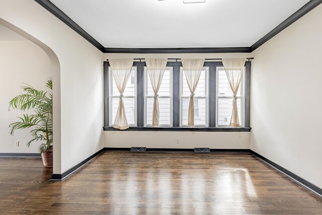 292 W 15th Pl, Chicago Heights, IL 60411 - spare room featuring arched walkways, ornamental molding, wood finished floors, and visible vents