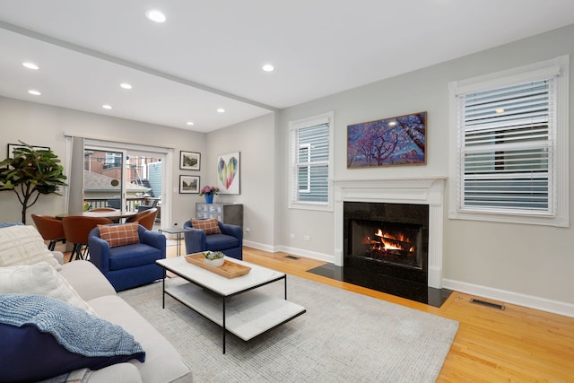 3727 N Paulina St, Chicago, IL 60613 - living area with a fireplace with flush hearth, wood finished floors, baseboards, and recessed lighting