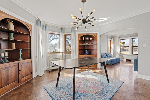 office featuring arched walkways, crown molding, baseboards, a chandelier, and built in features