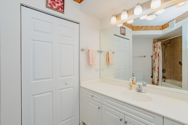 bathroom with visible vents, vanity, a closet, and toilet