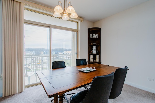 office area featuring a chandelier, carpet floors, baseboards, and plenty of natural light