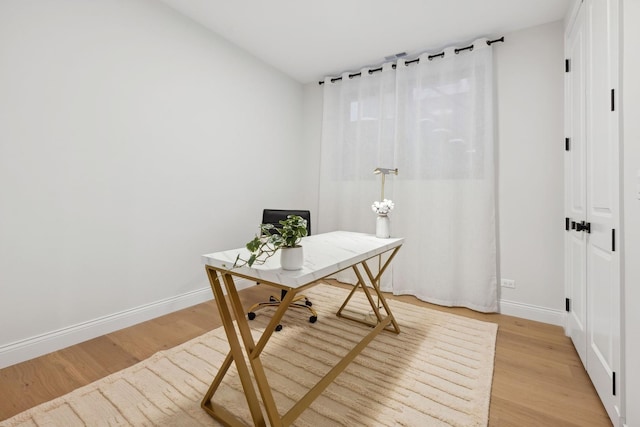 office space with light wood finished floors and baseboards