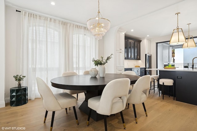 dining room featuring a chandelier, light wood-style floors, and recessed lighting