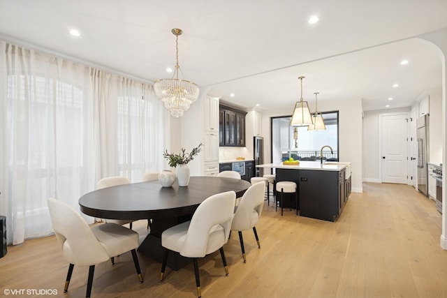 dining room featuring a chandelier, light wood-style flooring, recessed lighting, and baseboards