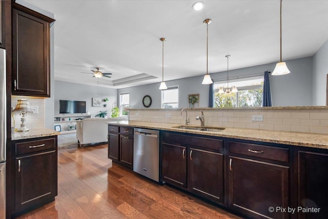 1348 Ritter St, North Aurora, IL 60542 - living area with a ceiling fan, dark wood-style flooring, a raised ceiling, and baseboards