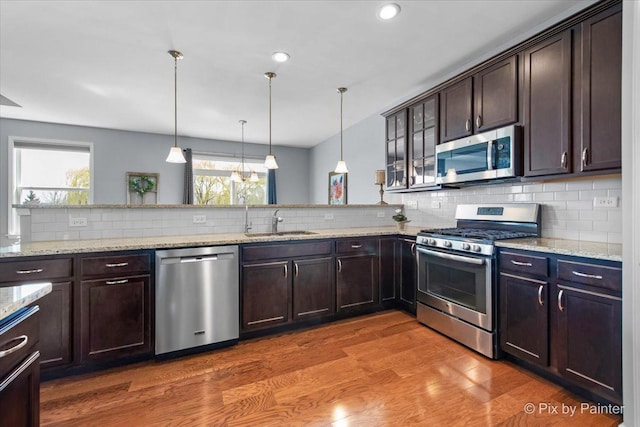 1348 Ritter St, North Aurora, IL 60542 - living area featuring wood finished floors, a raised ceiling, ceiling fan, and baseboards