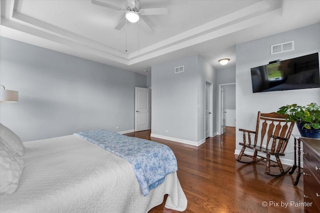 1348 Ritter St, North Aurora, IL 60542 - bedroom featuring visible vents, a tray ceiling, baseboards, wood finished floors, and a ceiling fan