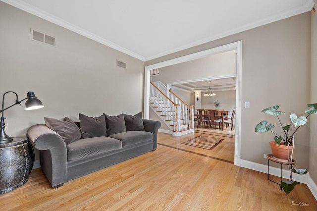 325 Bonnie Brae Ave, Itasca, IL 60143 - living area featuring ornamental molding, stairs, wood finished floors, and a chandelier