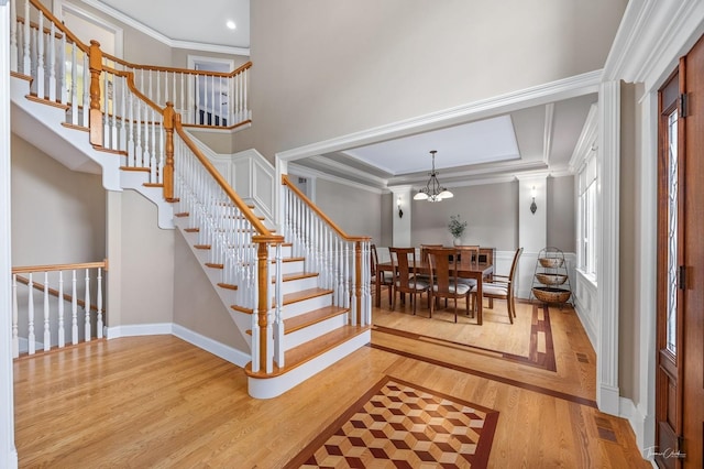 325 Bonnie Brae Ave, Itasca, IL 60143 - entryway with light wood finished floors, ornamental molding, a chandelier, stairway, and recessed lighting