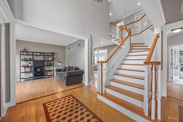 325 Bonnie Brae Ave, Itasca, IL 60143 - stairway featuring a high ceiling, wood finished floors, and crown molding
