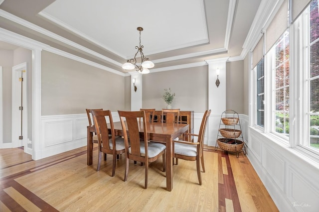 325 Bonnie Brae Ave, Itasca, IL 60143 - dining room with a raised ceiling, light wood-style flooring, wainscoting, a decorative wall, and ornamental molding