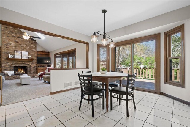 931 Sanctuary Ln, Naperville, IL 60540 - dining space featuring light tile patterned floors, a brick fireplace, lofted ceiling, and baseboards