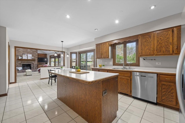 931 Sanctuary Ln, Naperville, IL 60540 - kitchen with light tile patterned floors, a sink, appliances with stainless steel finishes, light countertops, and a center island