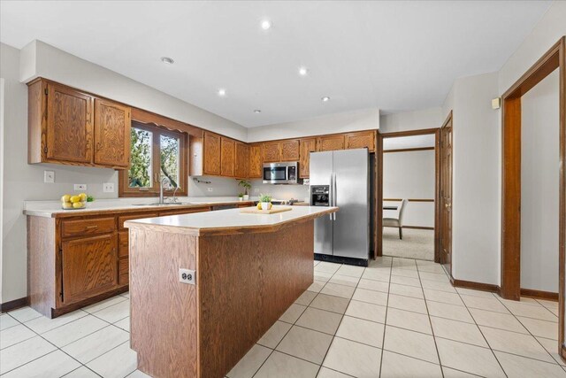 931 Sanctuary Ln, Naperville, IL 60540 - kitchen with brown cabinets, a sink, stainless steel appliances, a kitchen island, and light countertops