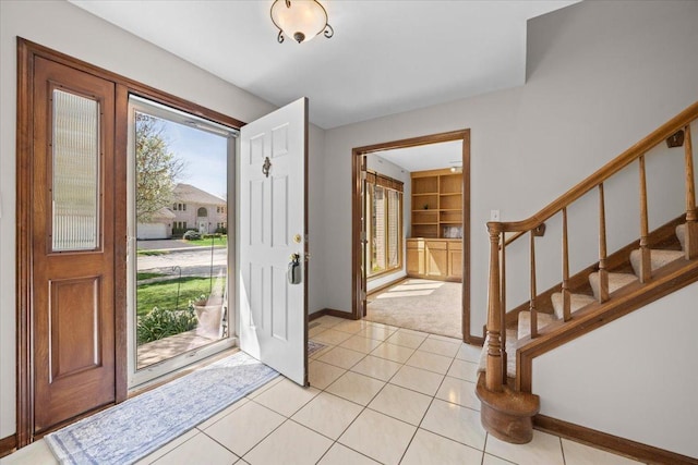 931 Sanctuary Ln, Naperville, IL 60540 - entryway with light tile patterned floors, stairs, light carpet, and baseboards