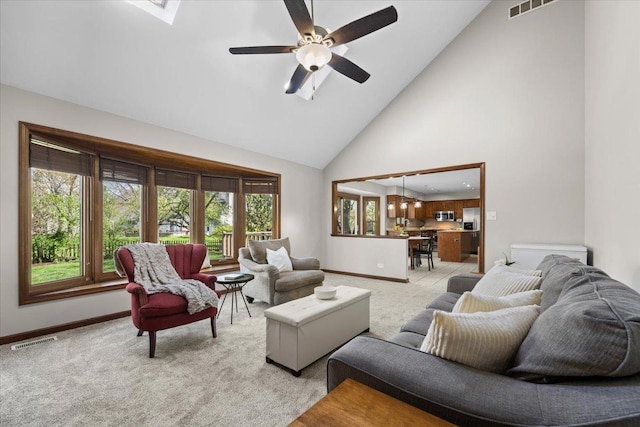 931 Sanctuary Ln, Naperville, IL 60540 - living room featuring visible vents, baseboards, high vaulted ceiling, and light carpet