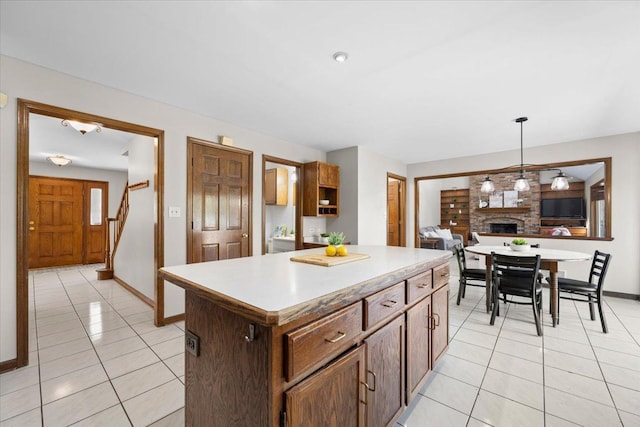 931 Sanctuary Ln, Naperville, IL 60540 - kitchen with light tile patterned floors, a center island, hanging light fixtures, and light countertops
