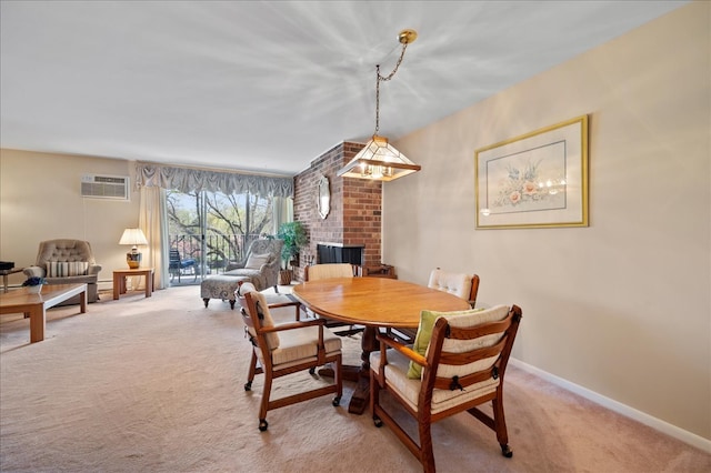 1053 W Ogden Ave Unit 350, Naperville, IL 60563 - dining space with baseboards, a wall mounted air conditioner, light colored carpet, and a brick fireplace