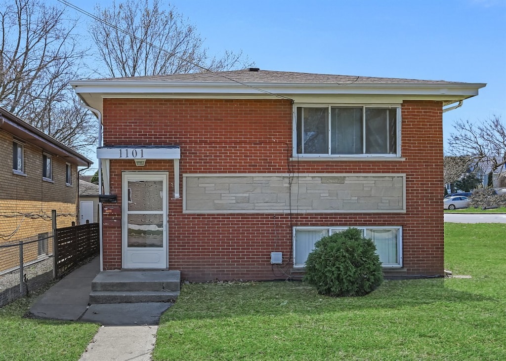 1101 Indian Ave, Aurora, IL 60505 - view of front of home with brick siding, fence, and a front yard