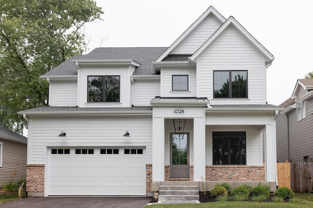 905 N Webster St, Naperville, IL 60563 - craftsman-style home with brick siding, aphalt driveway, a porch, and a garage