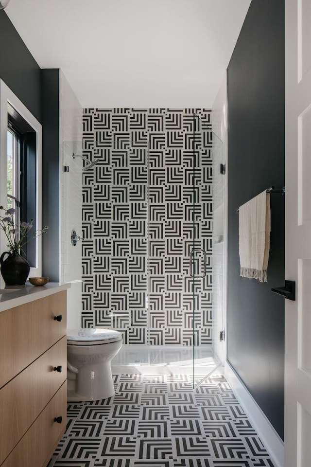 905 N Webster St, Naperville, IL 60563 - bathroom with vanity, toilet, tiled shower, and tile patterned floors