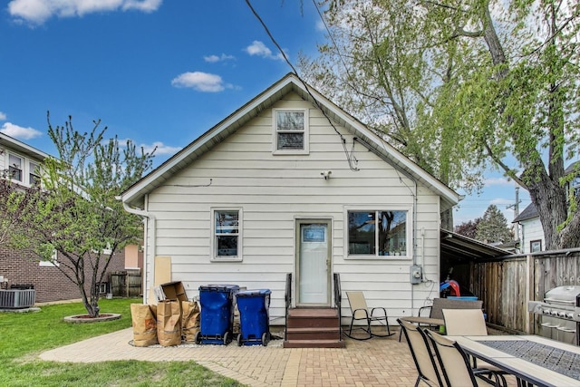 1325 Lincoln St, North Chicago, IL 60064 - back of property featuring a patio, central AC unit, and outdoor dining area