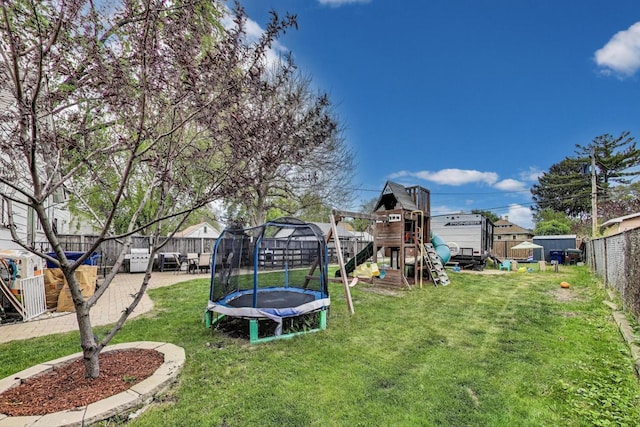1325 Lincoln St, North Chicago, IL 60064 - view of yard featuring a trampoline, a playground, and a patio