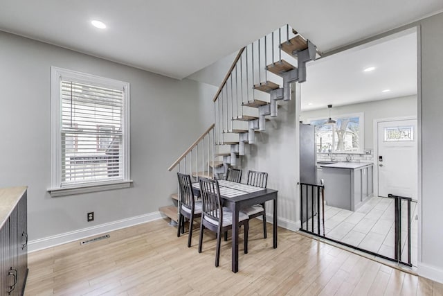 1325 Lincoln St, North Chicago, IL 60064 - dining room featuring light wood-type flooring, stairway, baseboards, and recessed lighting