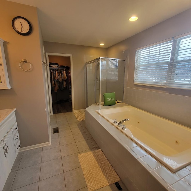 21526 Trick Circle Ct, Wilmington, IL 60481 - full bathroom featuring a shower stall, tile patterned flooring, vanity, a tub with jets, and a walk in closet