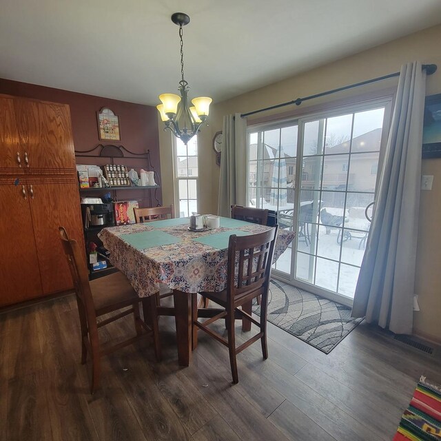 21526 Trick Circle Ct, Wilmington, IL 60481 - dining room featuring a notable chandelier, wood finished floors, and visible vents