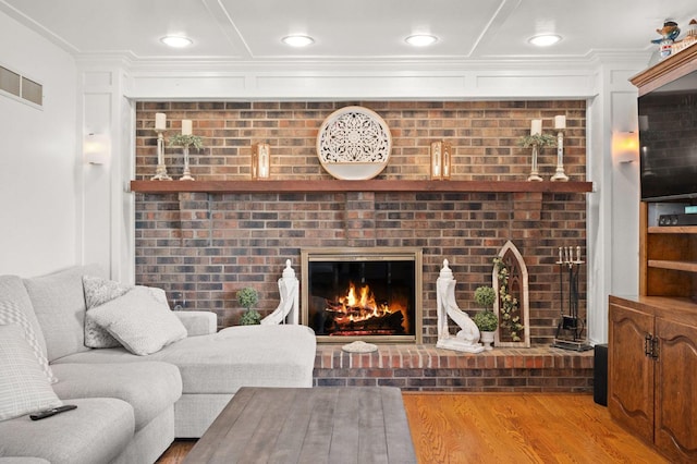 41W838 High Point Ln, Elburn, IL 60119 - living area featuring a brick fireplace, wood finished floors, ornamental molding, and recessed lighting