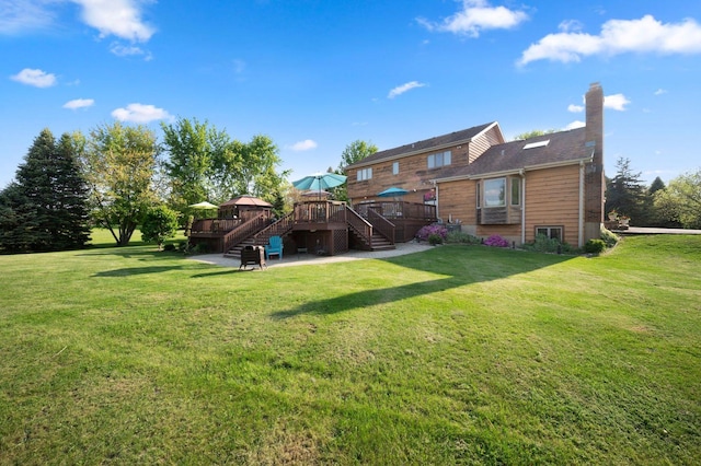 41W838 High Point Ln, Elburn, IL 60119 - back of property featuring stairs, a wooden deck, a chimney, a lawn, and a patio