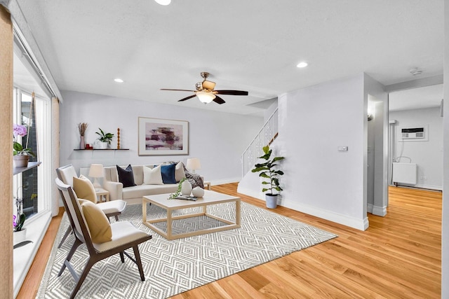 living area with recessed lighting, light wood-style floors, baseboards, and ceiling fan