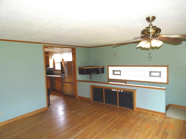 5837 N Navarre Ave, Chicago, IL 60631 - unfurnished living room featuring a ceiling fan, wood finished floors, baseboards, a textured ceiling, and ornamental molding