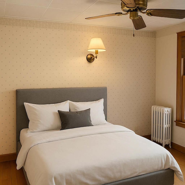 5837 N Navarre Ave, Chicago, IL 60631 - bedroom with radiator heating unit, wood finished floors, baseboards, a ceiling fan, and crown molding