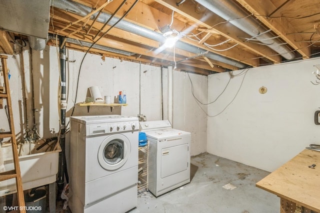 clothes washing area with washer and dryer and laundry area