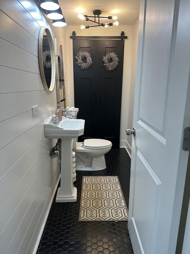 bathroom with baseboards and toilet