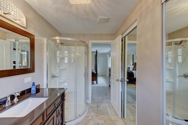 bathroom featuring marble finish floor, ensuite bath, vanity, and a stall shower