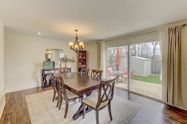 dining space featuring recessed lighting, wood finished floors, baseboards, and a notable chandelier