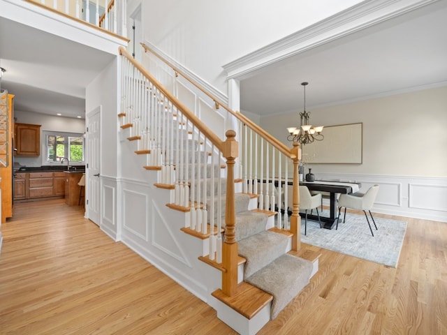 3035 Rollingridge Rd, Naperville, IL 60564 - stairs with ornamental molding, a decorative wall, wood finished floors, and a notable chandelier