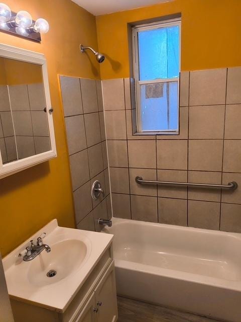 full bath featuring wood finished floors, shower / bathtub combination, and vanity