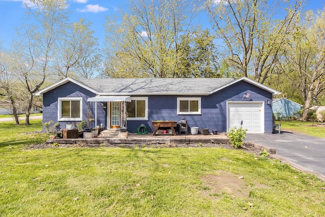 single story home featuring a garage, a front yard, roof with shingles, and aphalt driveway