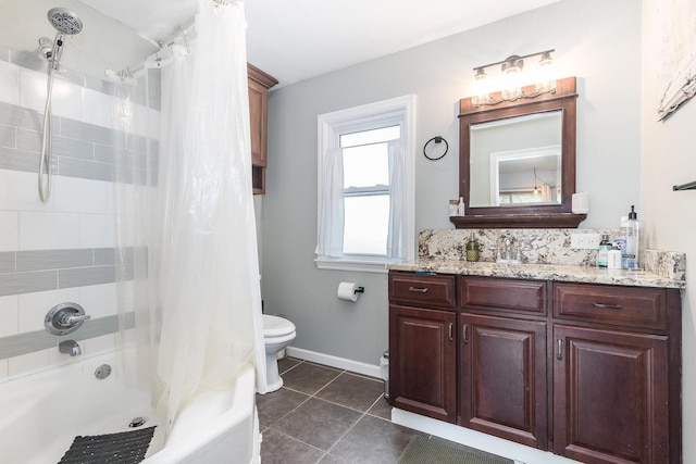 full bath with vanity, toilet, baseboards, tile patterned floors, and shower / bath combo