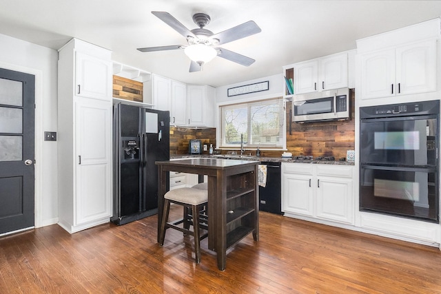 kitchen featuring a sink, open shelves, black appliances, and white cabinetry