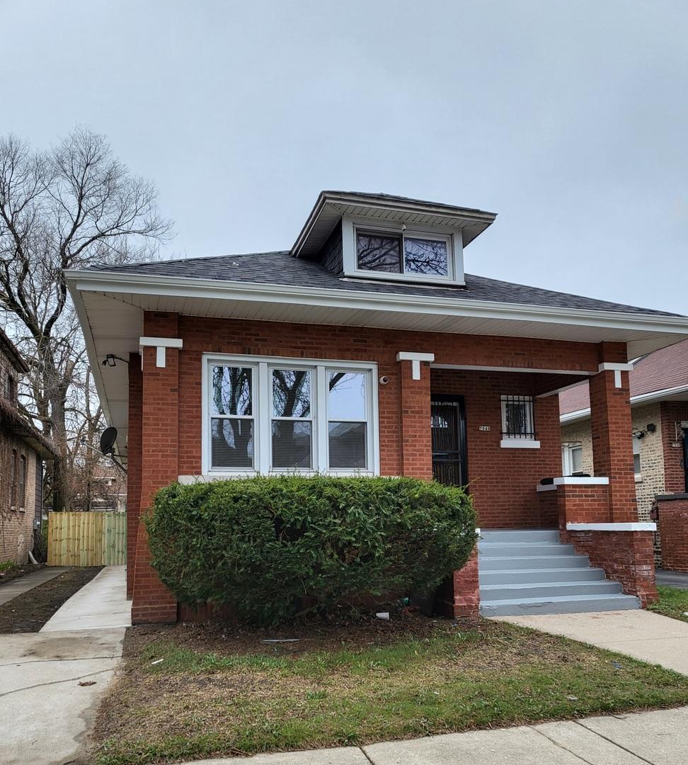 bungalow-style house with brick siding, fence, and a porch