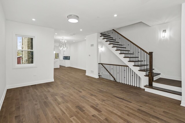 6460 S Kenwood Ave, Chicago, IL 60637 - unfurnished living room featuring recessed lighting, stairway, a chandelier, baseboards, and wood finished floors
