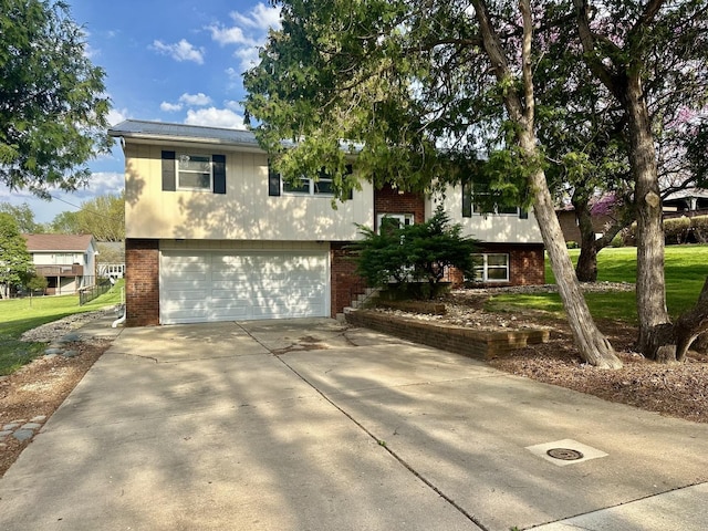 748 Marcy St, Ottawa, IL 61350 - raised ranch featuring an attached garage, brick siding, and driveway