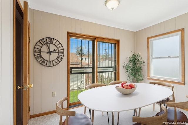 dining space featuring a decorative wall